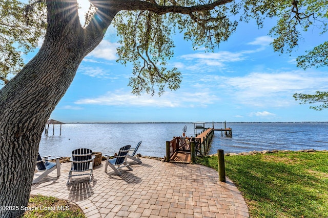 view of patio with a dock and a water view