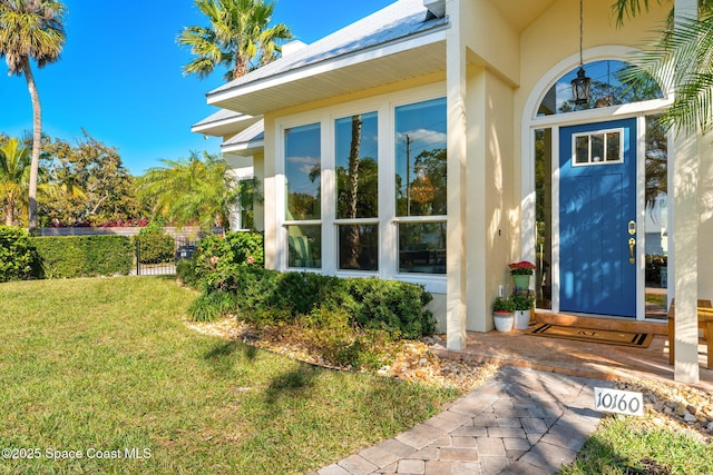 property entrance with a lawn