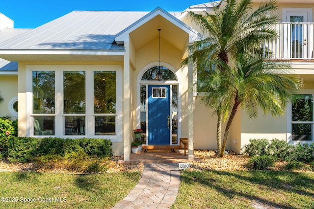 view of exterior entry with a lawn