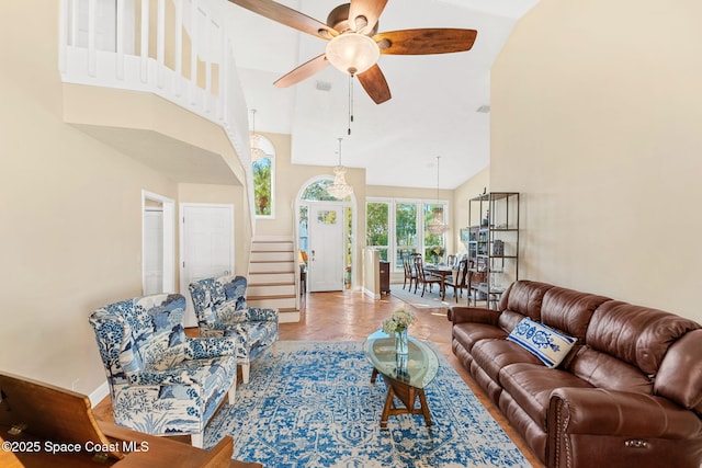 living room featuring ceiling fan and high vaulted ceiling