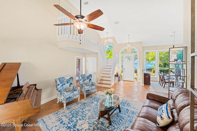 living room with ceiling fan, high vaulted ceiling, and light tile patterned floors