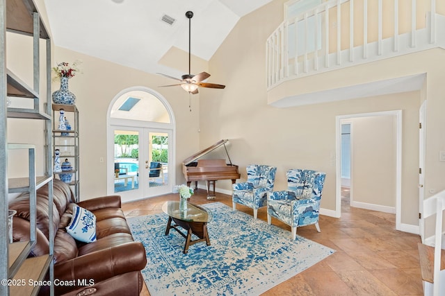 living room with ceiling fan, high vaulted ceiling, and french doors