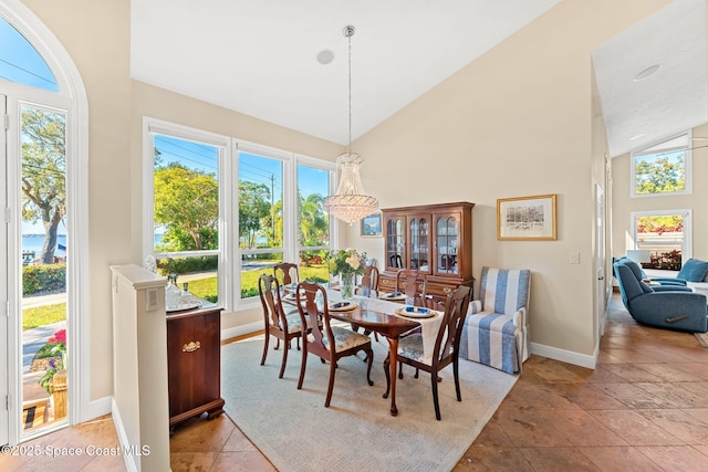 dining area with high vaulted ceiling