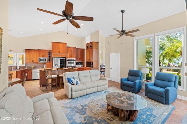 living room featuring sink, high vaulted ceiling, and ceiling fan