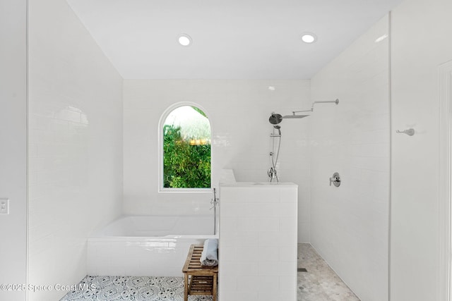 bathroom with tile patterned flooring and independent shower and bath