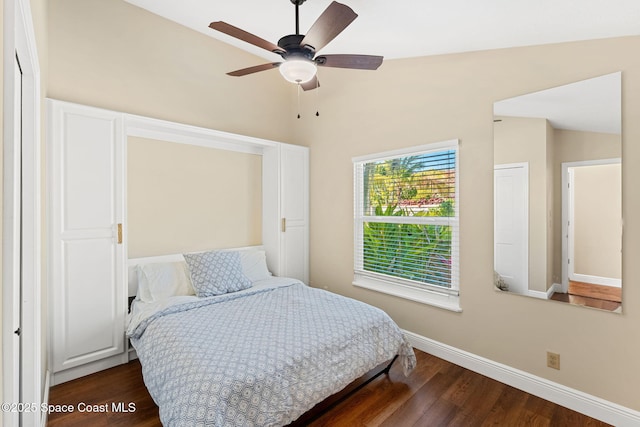 bedroom with lofted ceiling, dark wood-type flooring, and ceiling fan