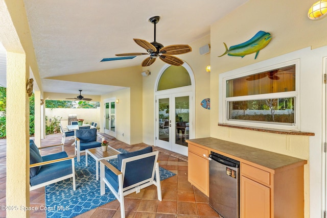 view of patio featuring french doors, ceiling fan, and exterior kitchen