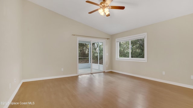 empty room featuring hardwood / wood-style flooring, vaulted ceiling, and ceiling fan