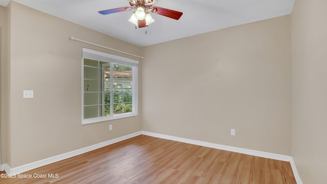 spare room featuring hardwood / wood-style flooring and ceiling fan