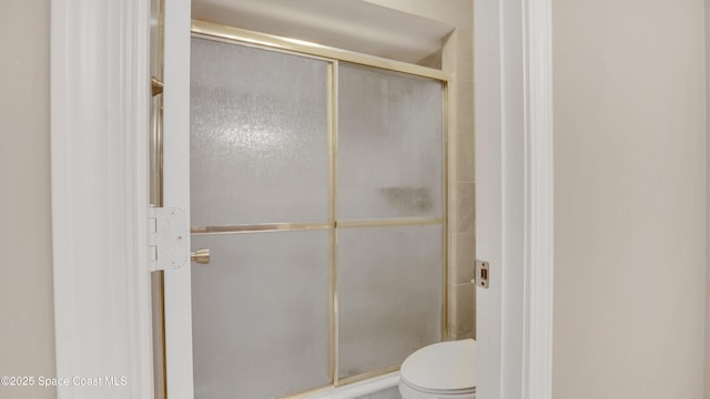 bathroom with toilet and walk in shower