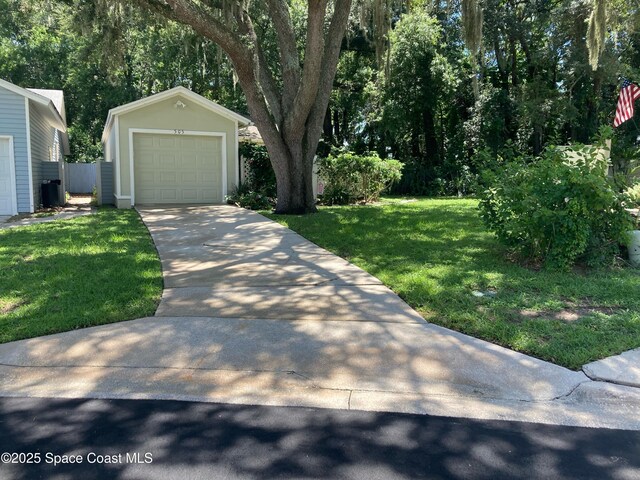 exterior space with a garage and an outbuilding