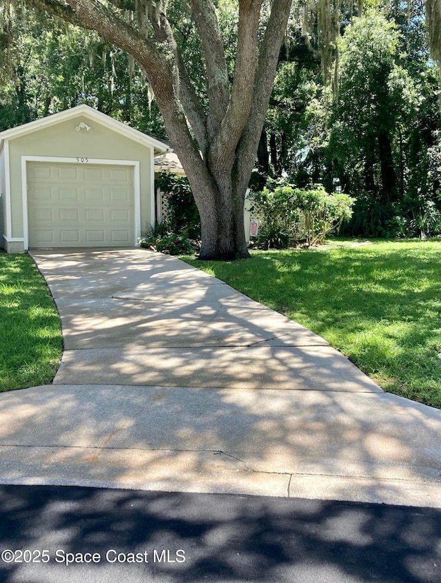 view of front facade with a garage, an outdoor structure, and a front yard