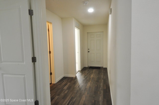 corridor with dark hardwood / wood-style flooring