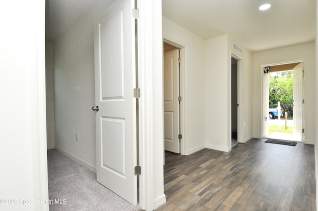 hall featuring wood finished floors, recessed lighting, baseboards, and visible vents