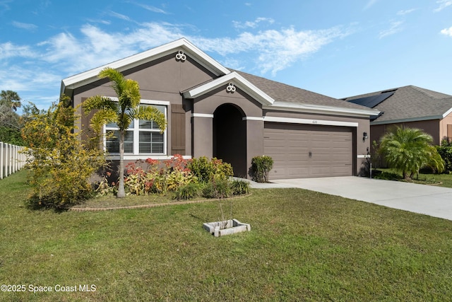 view of front of property featuring a garage and a front lawn