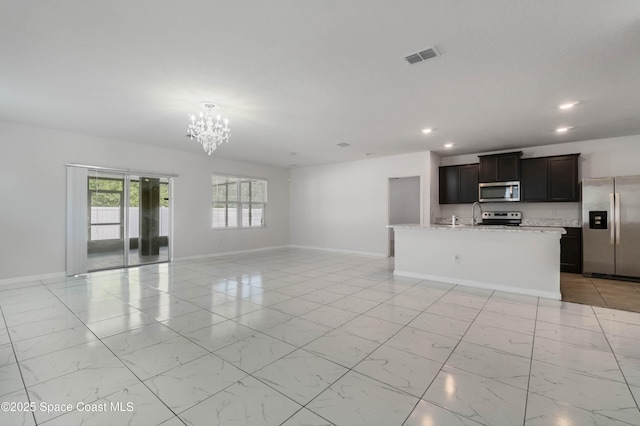 unfurnished living room featuring an inviting chandelier