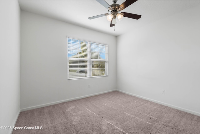 unfurnished room featuring ceiling fan and carpet flooring