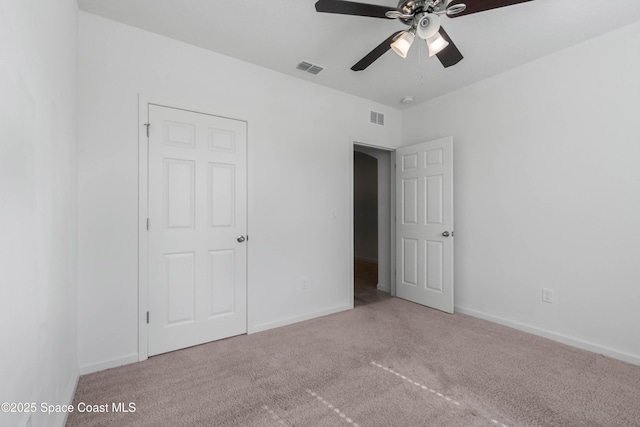 unfurnished bedroom featuring ceiling fan and carpet flooring