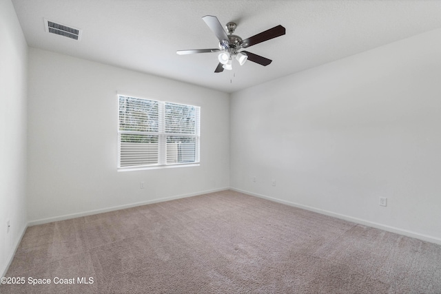 empty room with ceiling fan and carpet