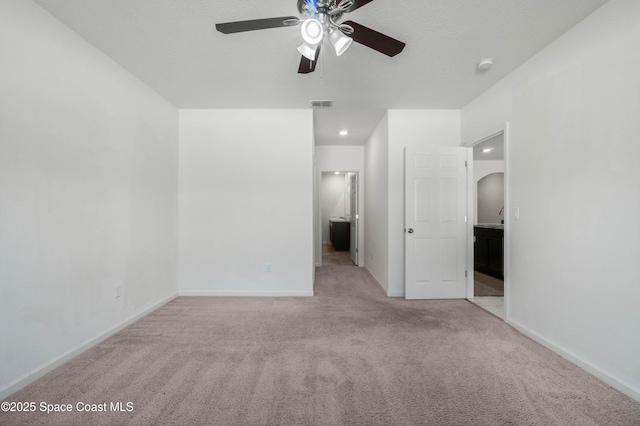 unfurnished bedroom featuring light colored carpet and ceiling fan