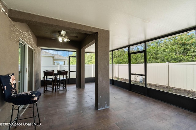 sunroom / solarium featuring ceiling fan