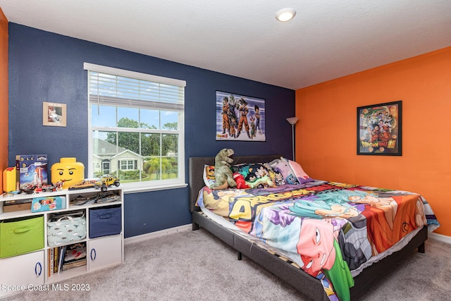 bedroom featuring carpet flooring and a textured ceiling