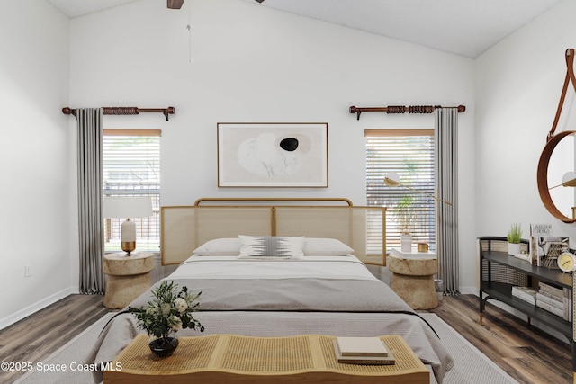 bedroom with wood finished floors, baseboards, and multiple windows