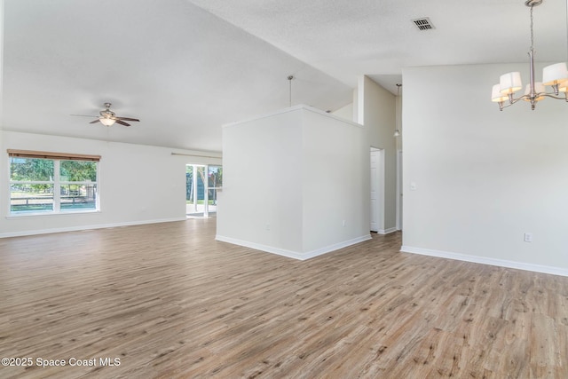 unfurnished room featuring visible vents, baseboards, light wood-type flooring, and ceiling fan with notable chandelier