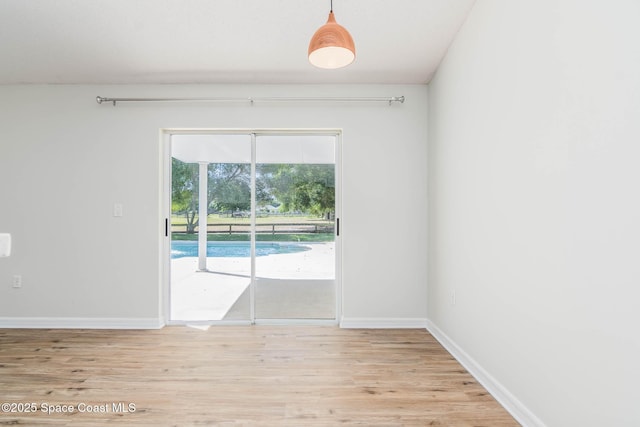 empty room with light wood-style floors and baseboards