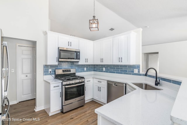 kitchen featuring a sink, light wood-type flooring, white cabinetry, and stainless steel appliances