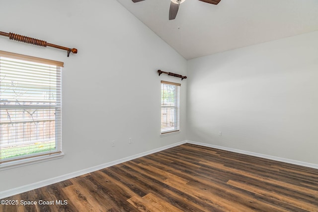 spare room featuring dark wood-type flooring, high vaulted ceiling, baseboards, and a ceiling fan