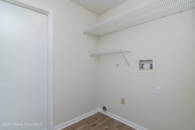 washroom with hookup for an electric dryer, baseboards, laundry area, hookup for a washing machine, and wood finished floors
