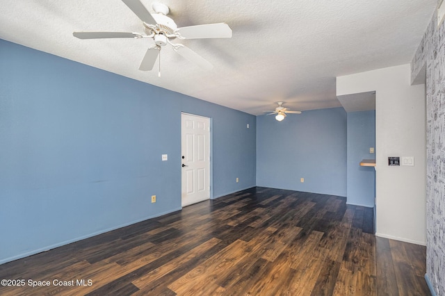 empty room with ceiling fan, dark hardwood / wood-style flooring, and a textured ceiling