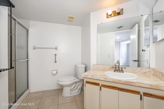 bathroom featuring an enclosed shower, vanity, tile patterned floors, and toilet