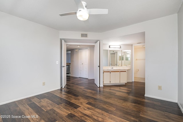 interior space with ceiling fan and dark hardwood / wood-style flooring