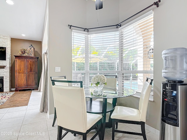 tiled dining room with a fireplace