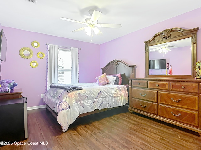 bedroom featuring dark hardwood / wood-style flooring and ceiling fan