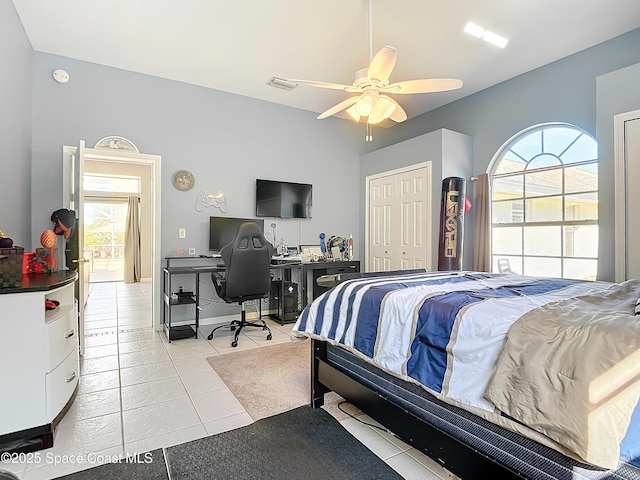 tiled bedroom with multiple windows, a closet, and ceiling fan