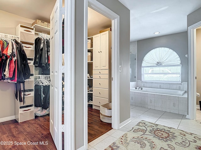 walk in closet with tile patterned floors