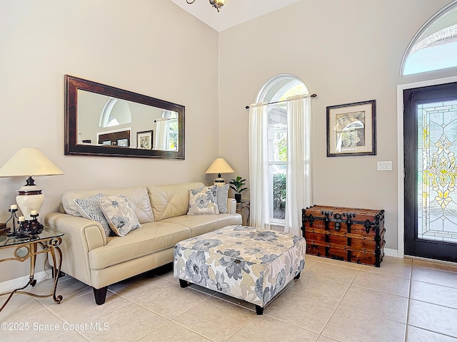 tiled living room featuring a towering ceiling