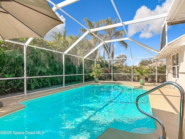 view of swimming pool featuring a lanai and a patio area