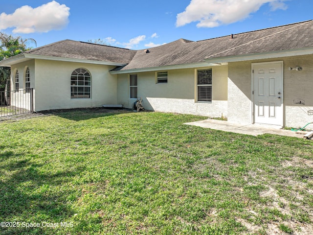 back of house with a yard