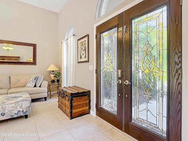 entryway featuring french doors and light tile patterned flooring