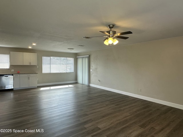 unfurnished living room with dark wood-type flooring and ceiling fan