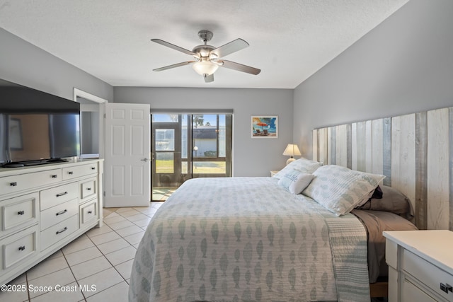 tiled bedroom featuring ceiling fan, access to outside, and a textured ceiling