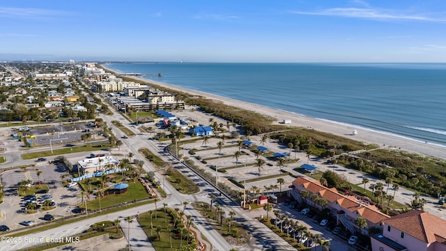 birds eye view of property with a view of the beach and a water view