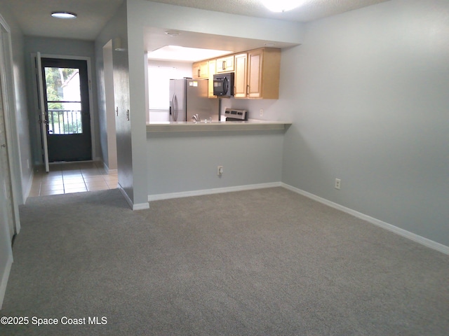 kitchen featuring stove, a textured ceiling, light carpet, stainless steel fridge with ice dispenser, and light brown cabinets