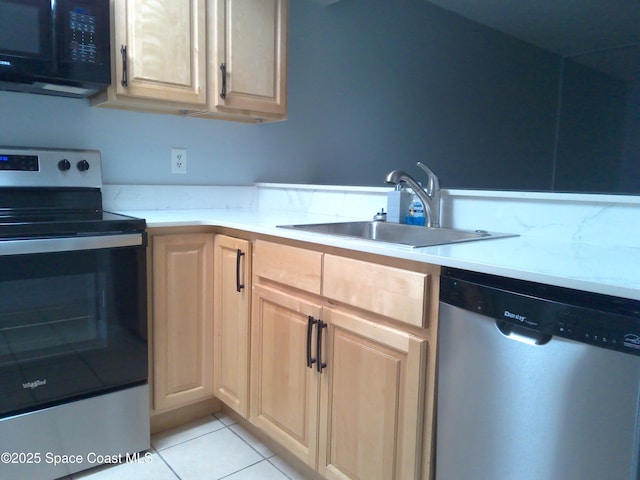 kitchen featuring stainless steel appliances, sink, light tile patterned floors, and light brown cabinetry