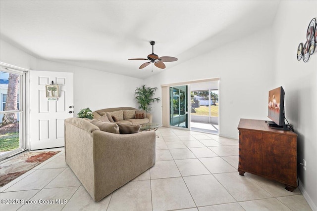 living room featuring light tile patterned flooring, ceiling fan, plenty of natural light, and vaulted ceiling