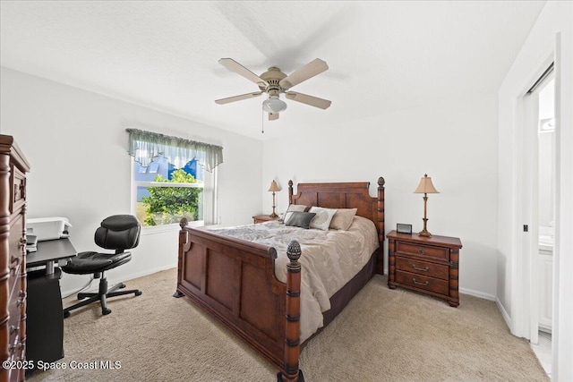 bedroom with ceiling fan and light carpet